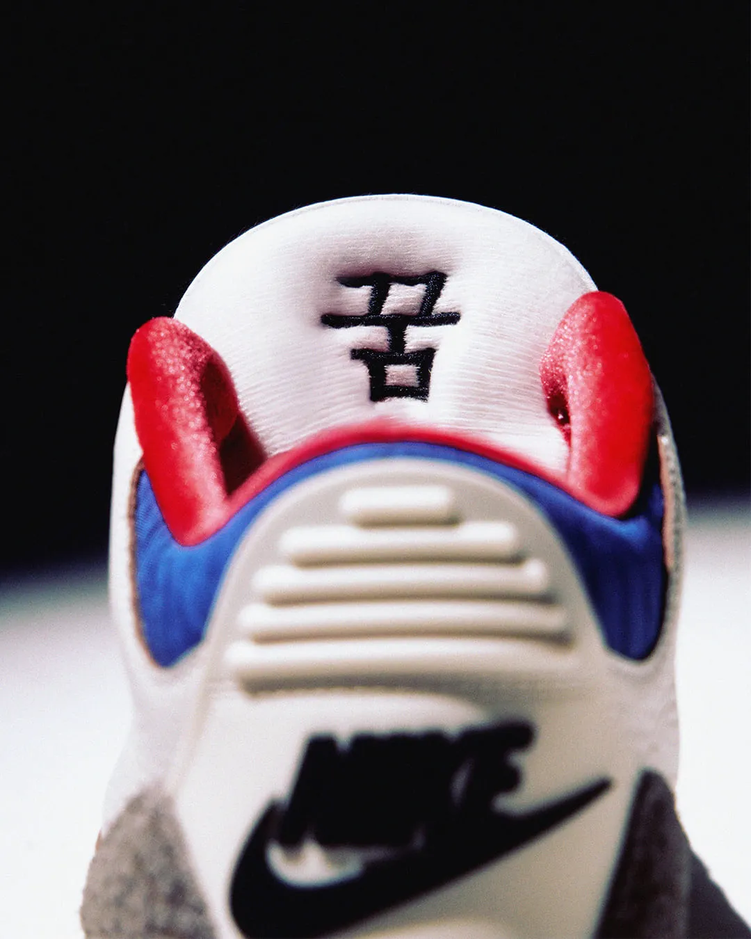 Close-up of Air Jordan 3 Seoul 2.0 tongue logo featuring the Taegeuk symbol