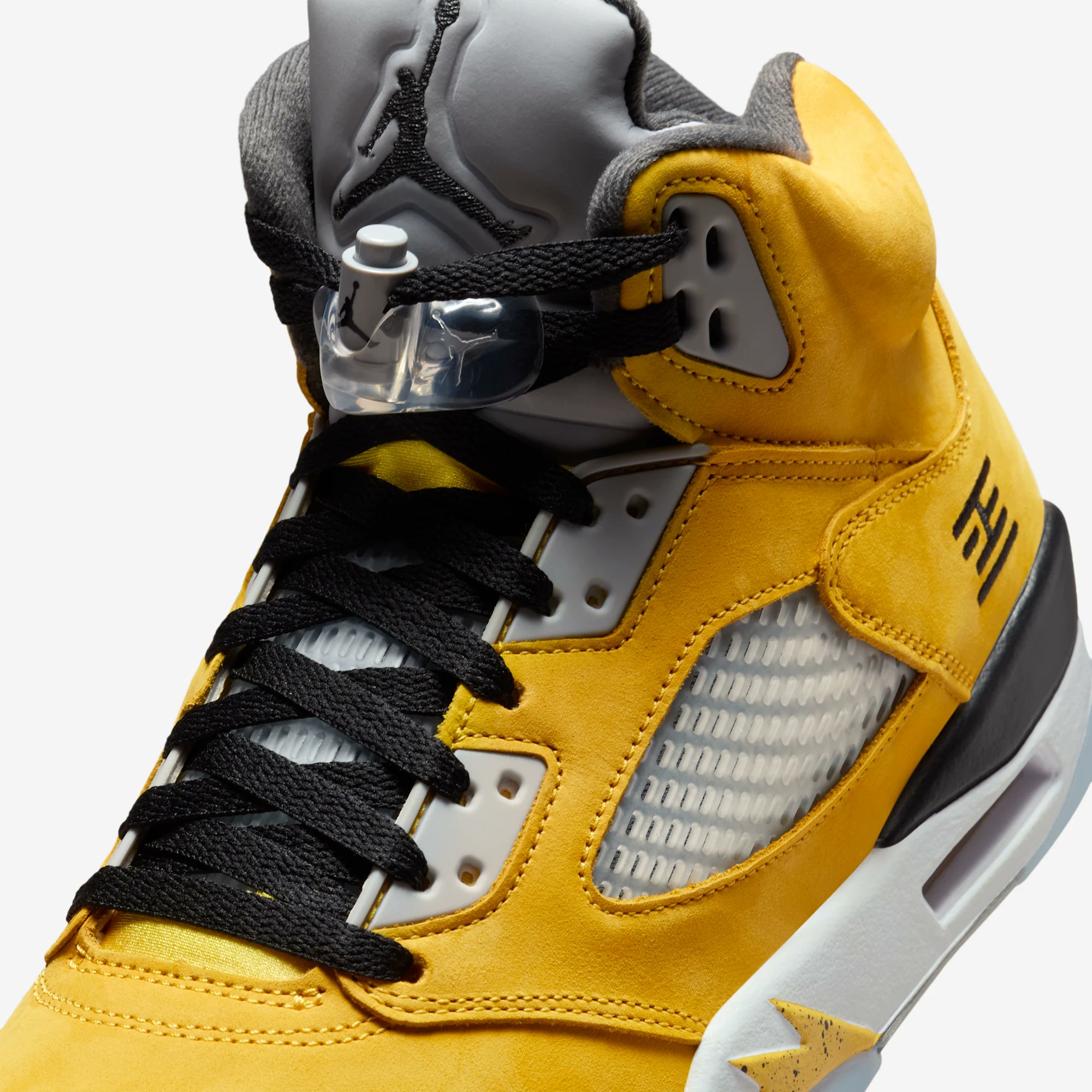 Side view of the Air Jordan 5 “Tokyo” featuring yellow upper and Tokyo 23 embroidery