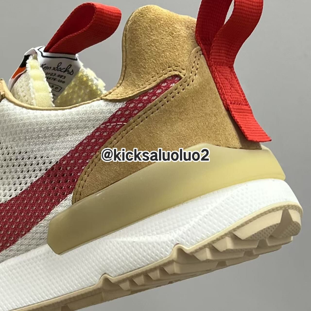 Tom Sachs x Nike Mars Yard 3.0 Heel view of the Tom Sachs x Nike Mars Yard 3.0 with red pull tab and mesh upper.