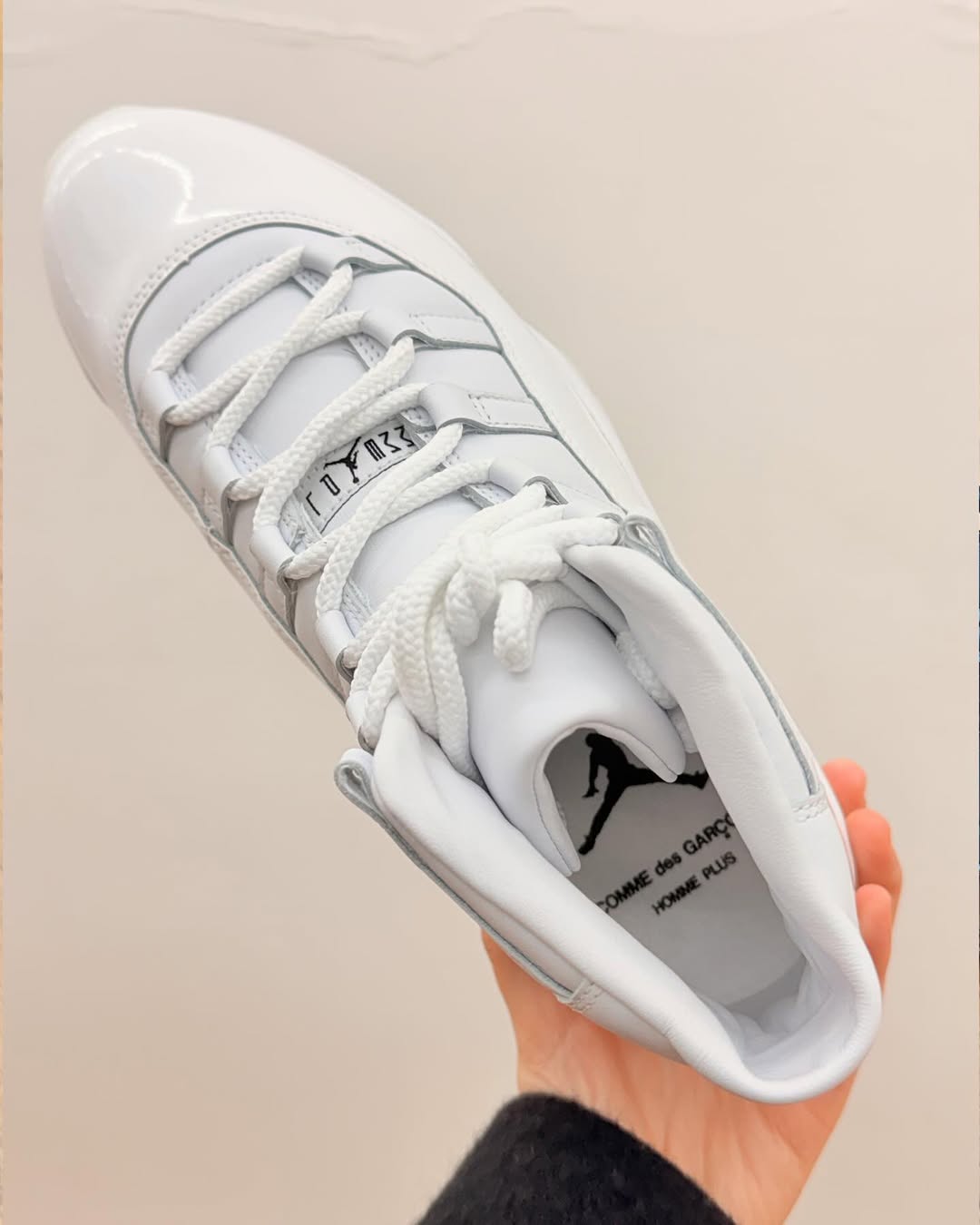 CDG x Air Jordan 11 white in hand