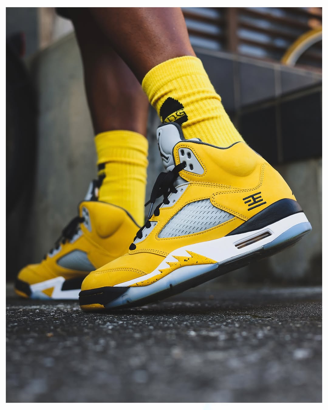 Side view of the Air Jordan 5 “Tokyo” featuring yellow upper and Tokyo 23 embroidery