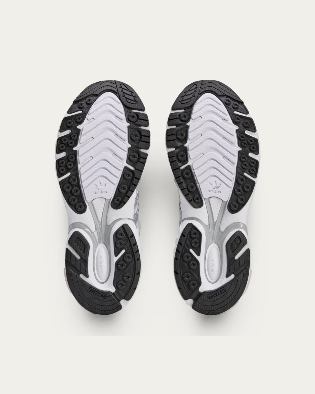 Outsole view of the Sporty & Rich x adidas Adistar Cushion "Grey" showcasing traction and design details.