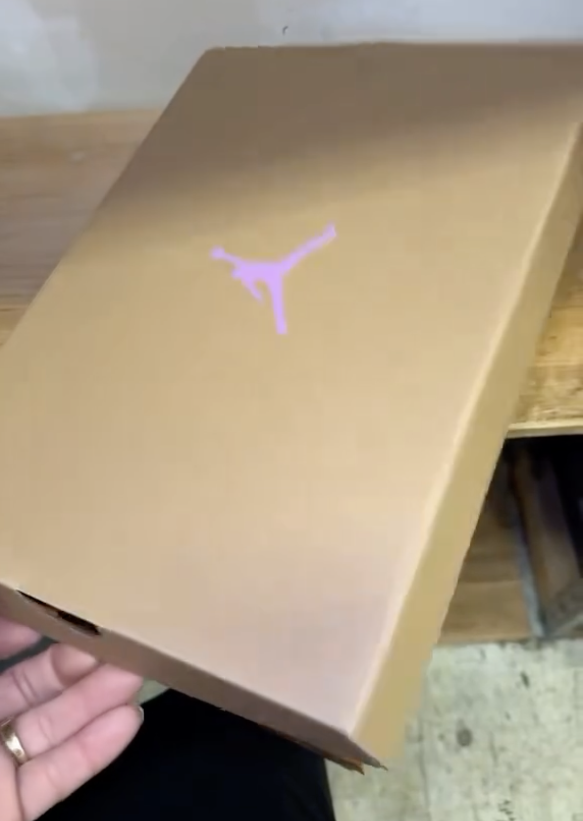 Peanut butter-colored Jordan box with pink Jumpman logo