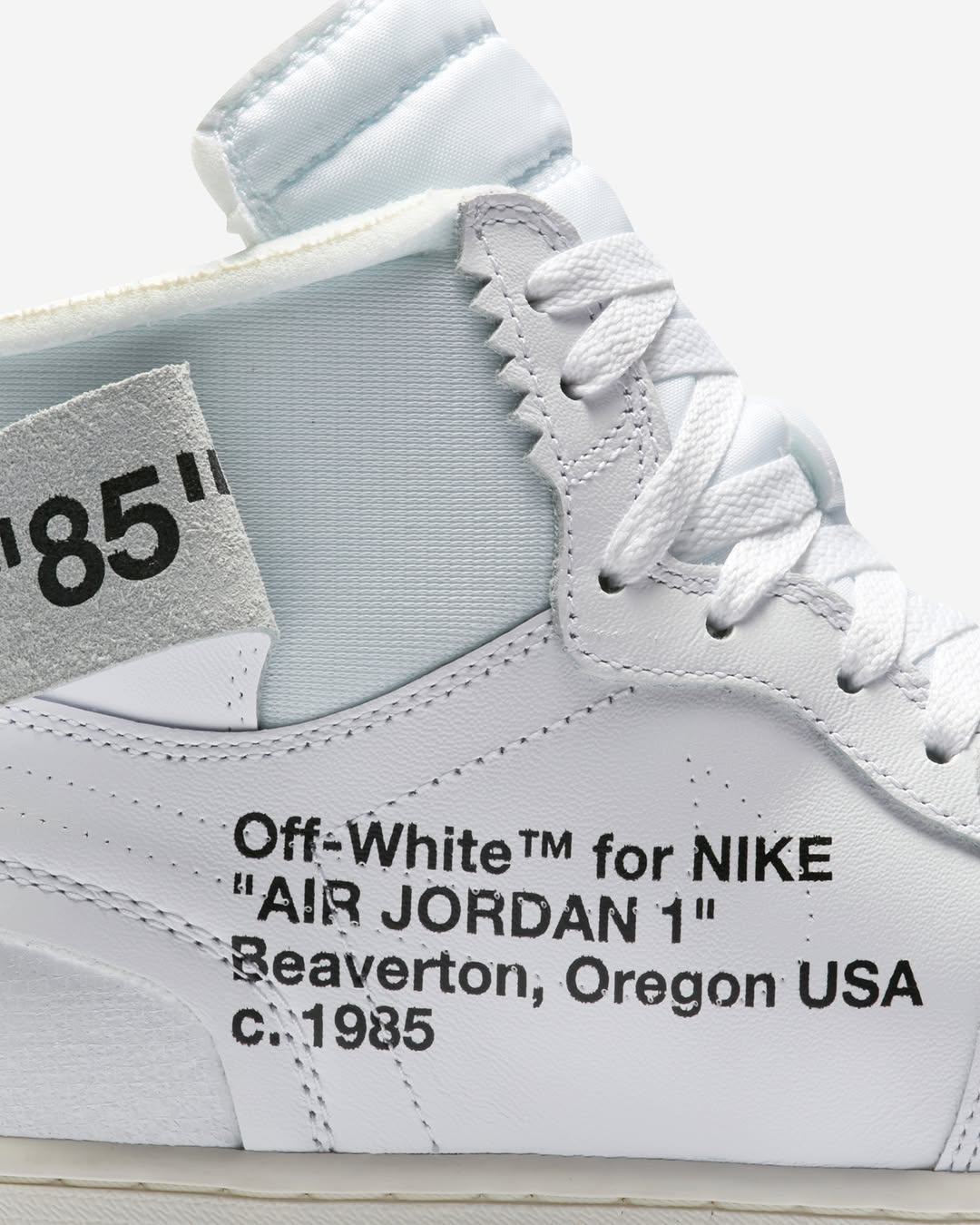 Close-up of the Off-White x Air Jordan 1 High “Alaska” with iconic Helvetica text and exposed foam collar.
