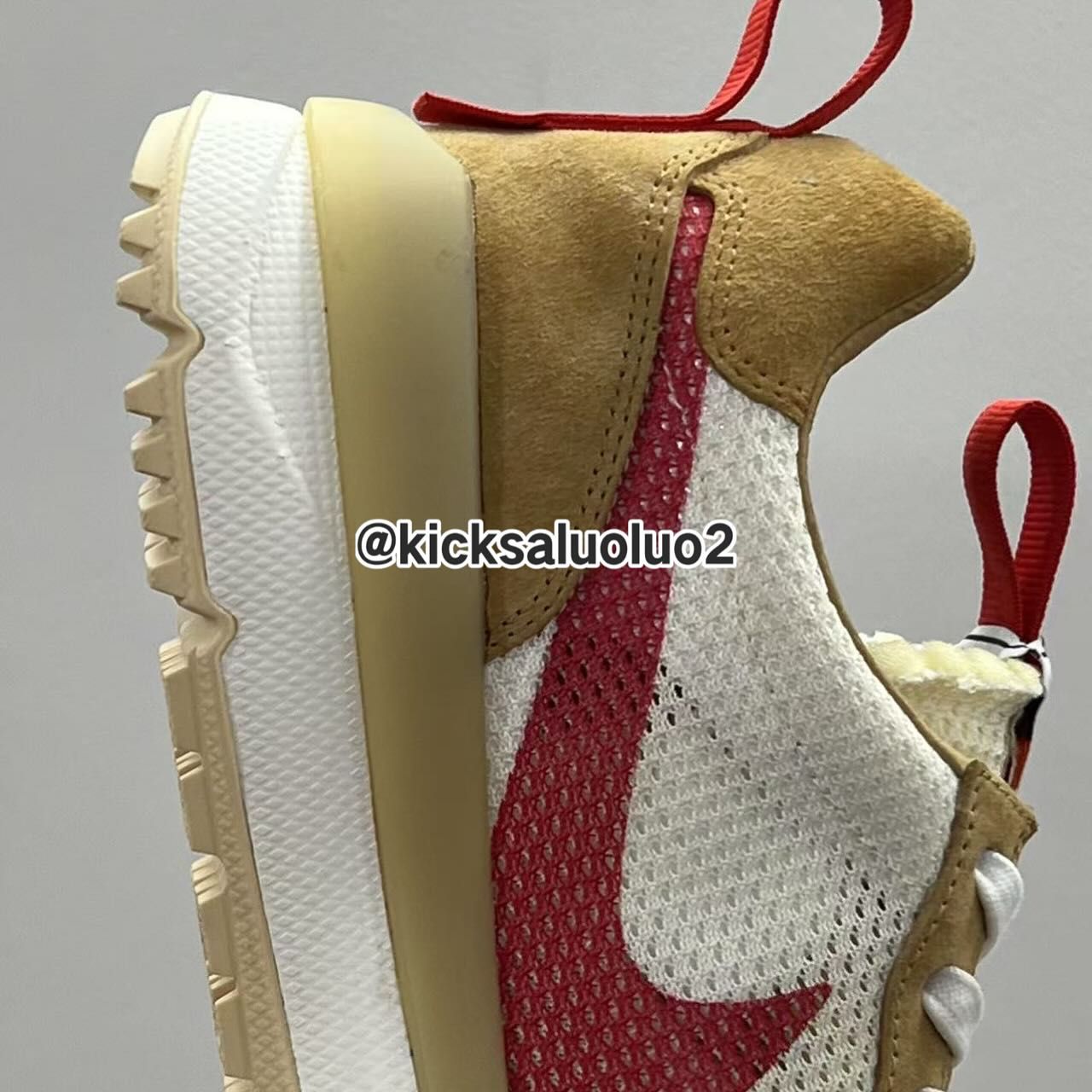 Tom Sachs x Nike Mars Yard 3.0 Side view of the Tom Sachs x Nike Mars Yard 3.0 showing red mesh Swoosh and beige suede overlays.