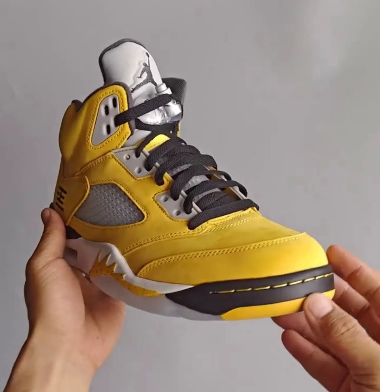 Front angle of the Air Jordan 5 “Tokyo” showing black tongue and yellow toe area