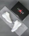 Top view of the Air Jordan 11 “Grand Finale” featuring white patent leather and chrome Jumpman logo