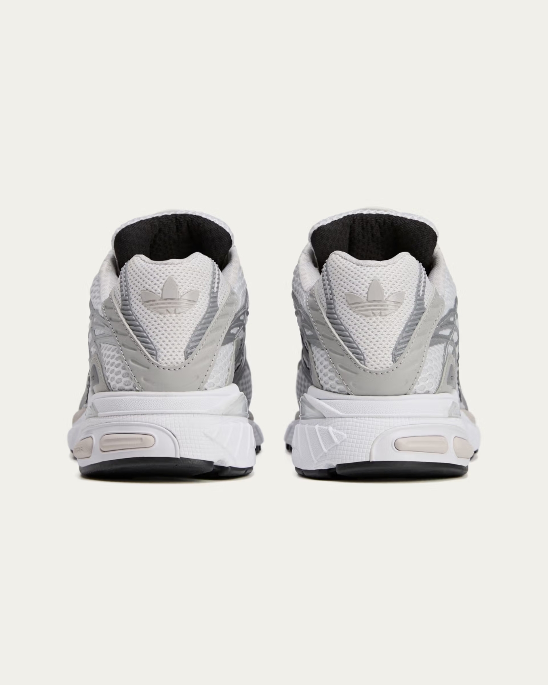 Rear view of the Sporty & Rich x adidas Adistar Cushion "Grey" featuring adidas branding on the heel tab.