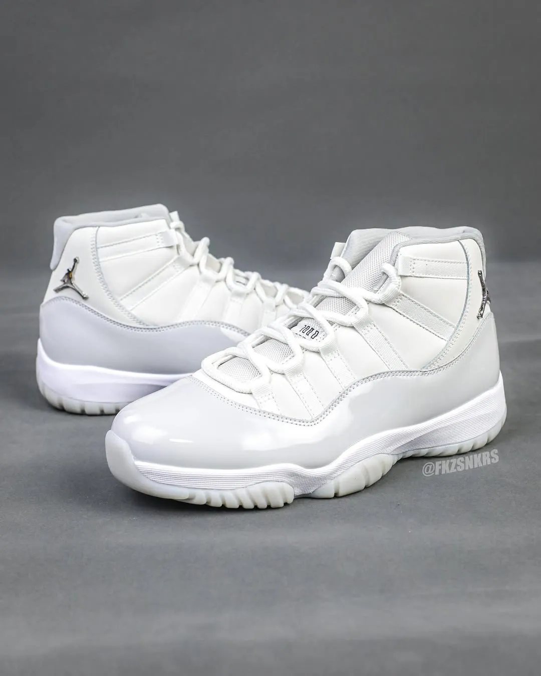 Air Jordan 11 Grand Finale Side view of the Air Jordan 11 “Grand Finale” featuring white patent leather and chrome Jumpman logo