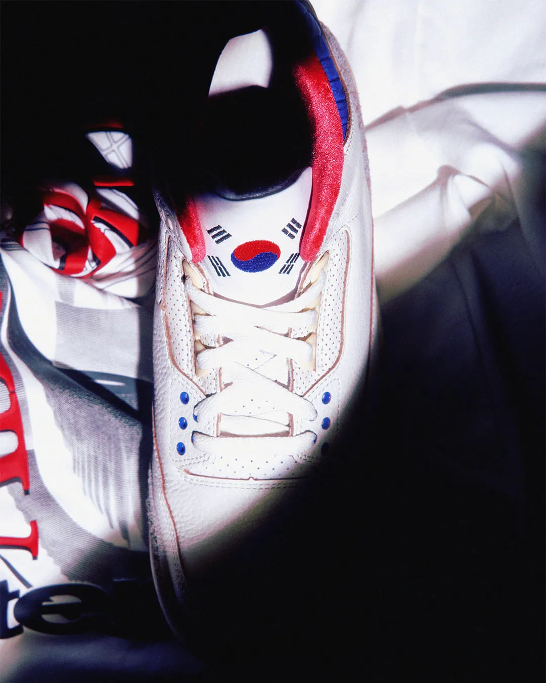 Close-up of Air Jordan 3 Seoul 2.0 tongue logo featuring the Taegeuk symbol