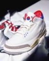 Close-up of Air Jordan 3 Seoul 2.0 tongue logo featuring the Taegeuk symbol