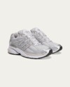 Profile view of the Sporty & Rich x adidas Adistar Cushion "Grey" displaying the retro running silhouette.