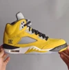 Side view of the Air Jordan 5 “Tokyo” featuring yellow upper and Tokyo 23 embroidery