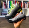 Detailed image of Nike Air Max 95 “Bright Mandarin” showcasing orange and grey accents with mesh upper and visible Air units.