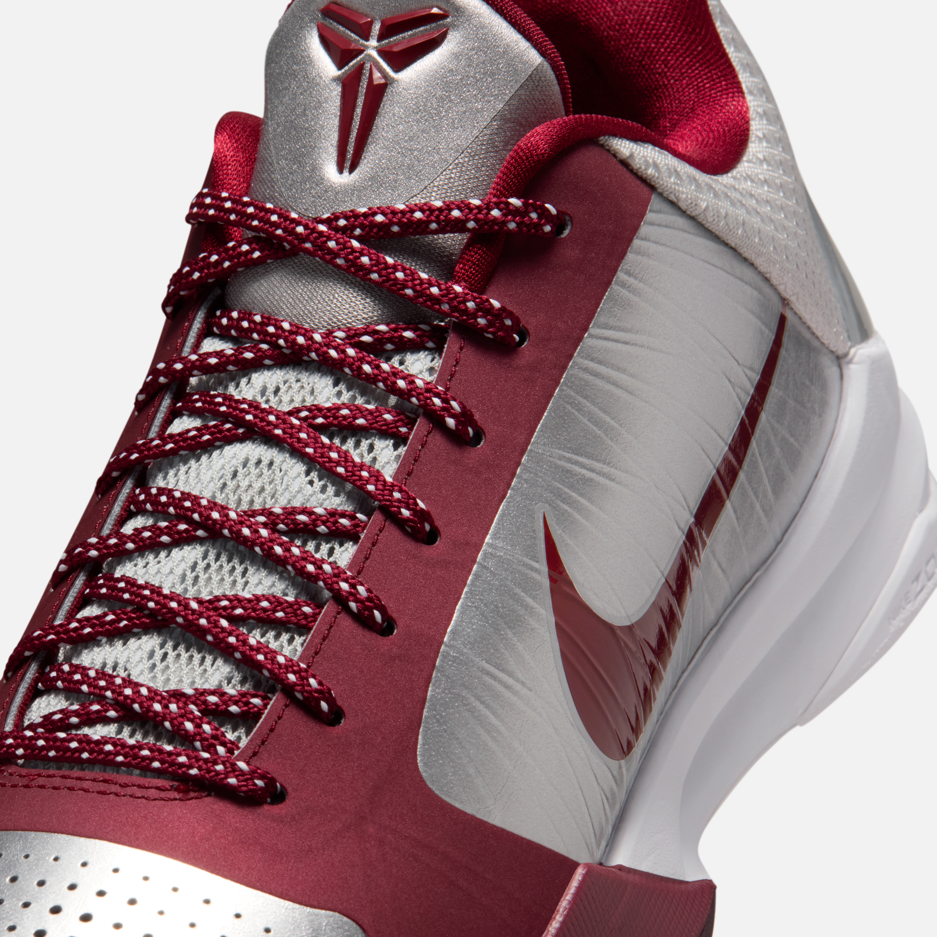 Side view of the Nike Kobe 5 Protro “Lower Merion Away” with silver-red upper and Swoosh
